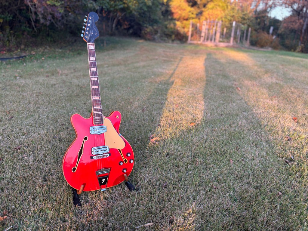 A 1966 Fender Coronado II in Candy Apple Red finish during golden hour. 