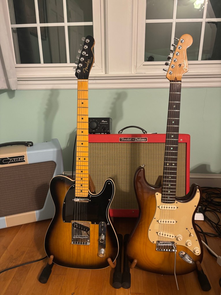 The guitar rig for The Night Wrecker: A Fender Hot Rod Deluxe (Texas Red) with a Bugera Attenuator, a Fender Telecaster Ultra Luxe and a Fender Stratocaster American Deluxe. The two guitars are sort of twins with their matching ash wood and burst finishes. 